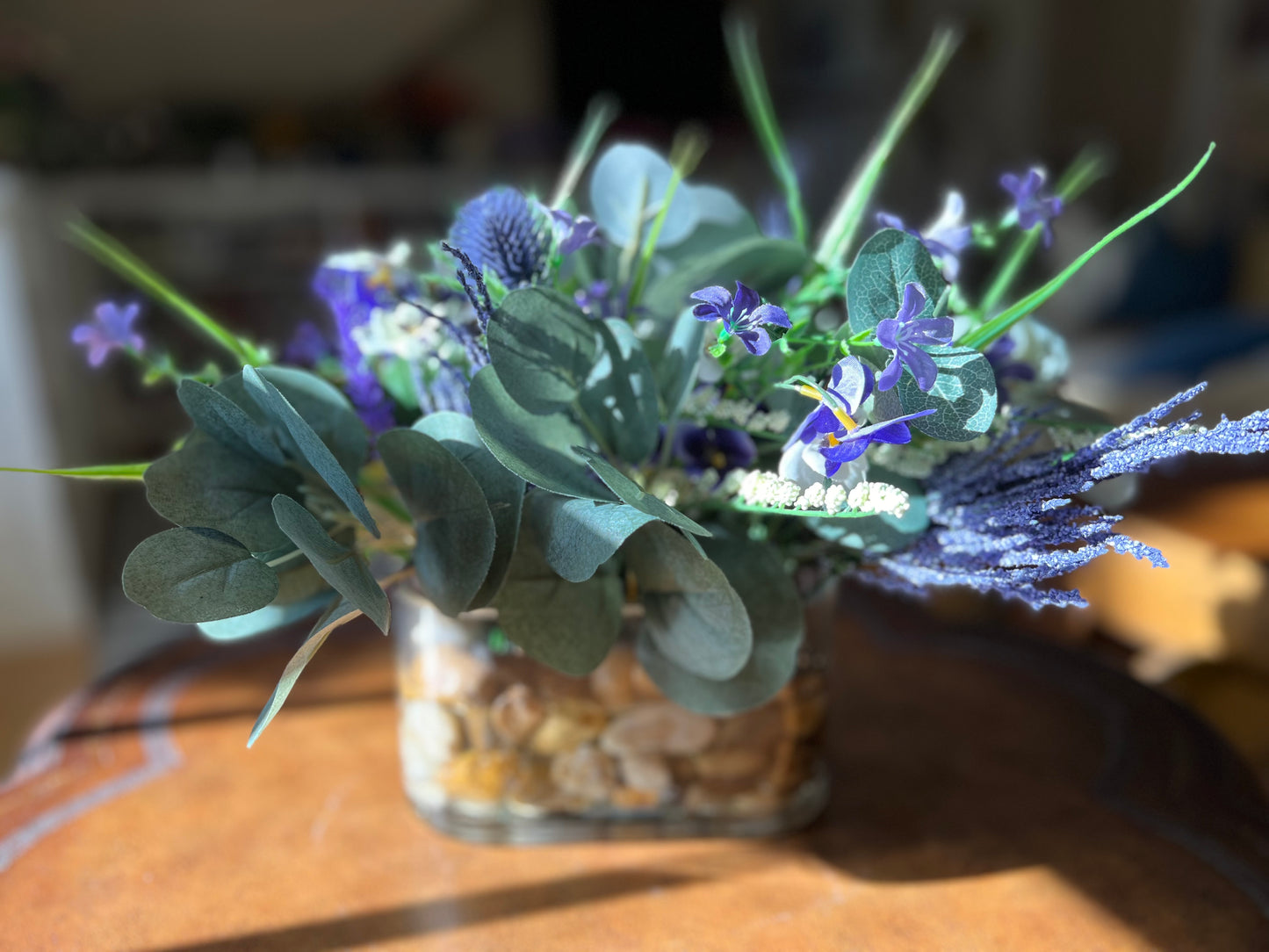 Pansies and Eucalyptus in Oval Vase