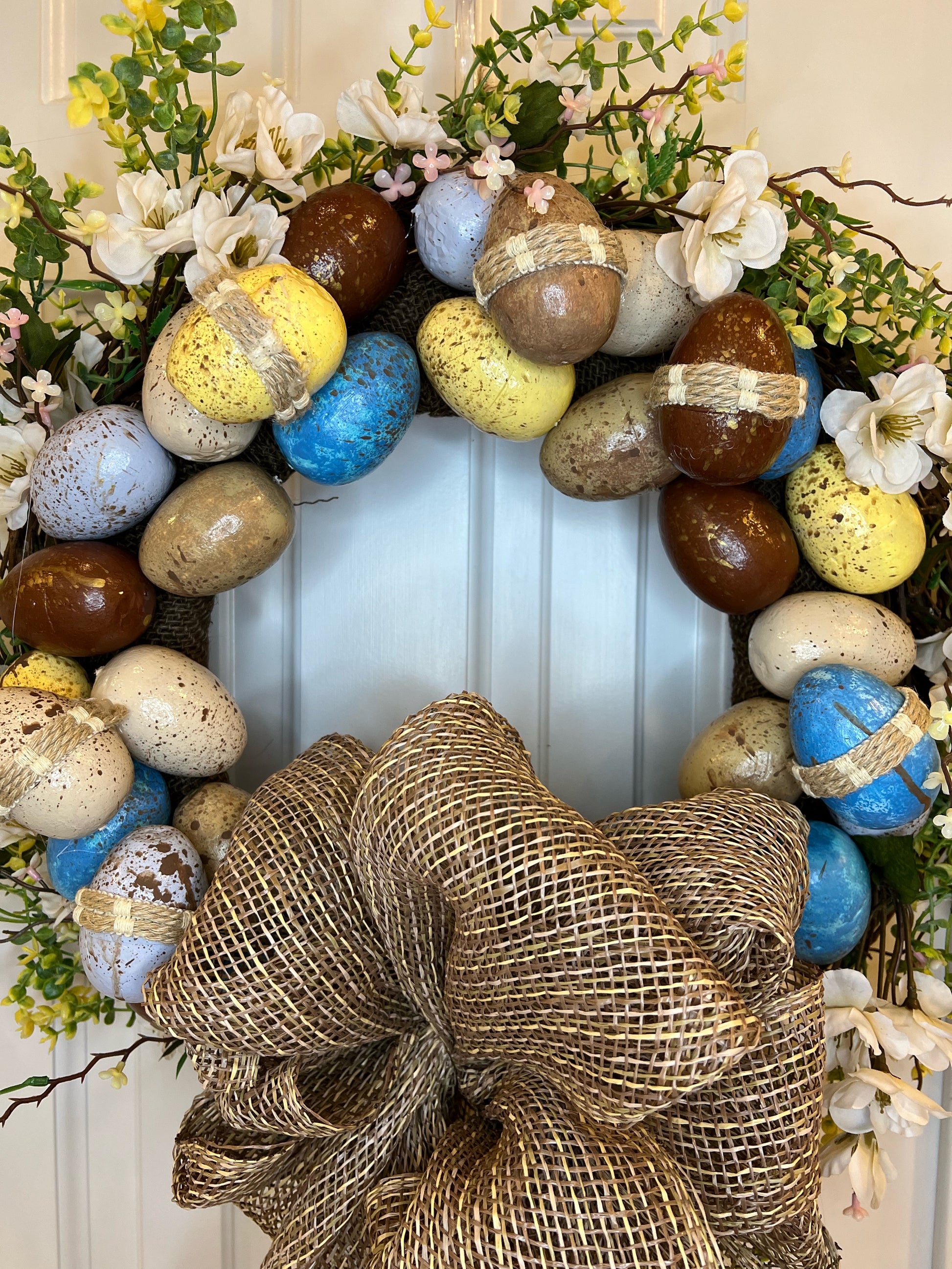 Row of easter eggs with decorative flower wreaths